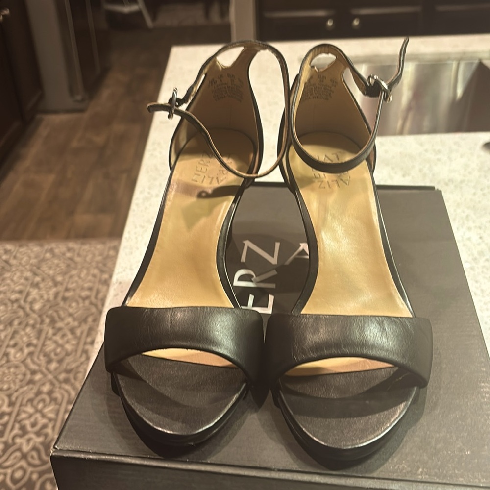 Naturalized black wedge shoe. 2 1/2 inches. Worn only once, practically new.